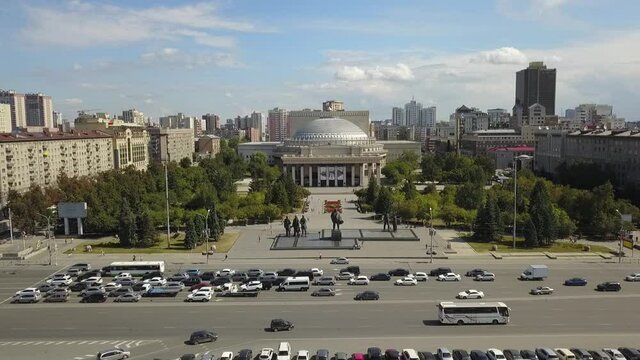 The flying camera shows the main attractions of Novosibirsk with a view of the city from and road traffic.