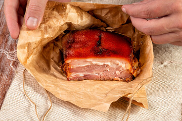 smoked meat wrapped in wrapping paper and tied with twine