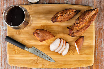 smoked meat lies on the table with herbs and sauce