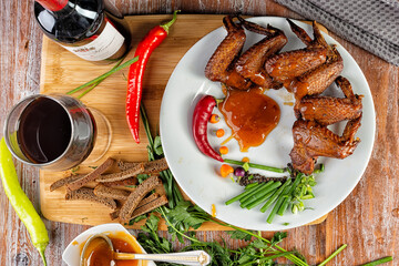 Composition with smoked chicken wings on the table