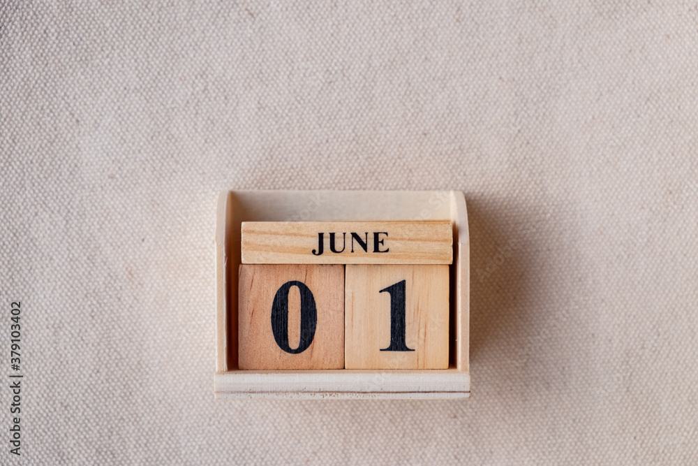 Fototapete june 1st. image of june 1 wooden color calendar on white canvas background. empty space for text