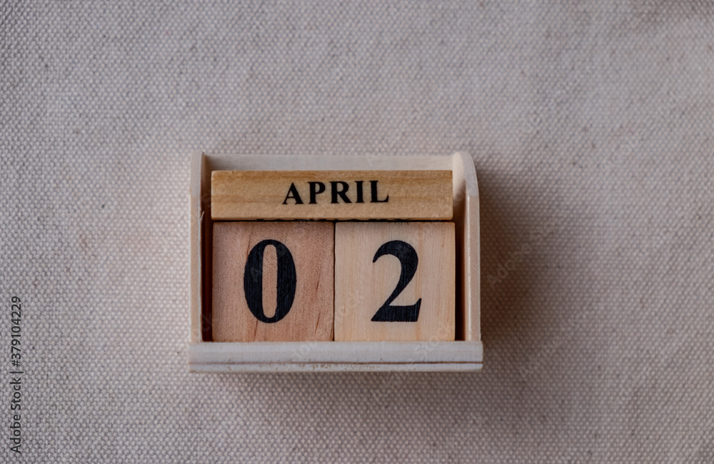 Fototapete april 2nd. image of april 2 wooden color calendar on white canvas background. empty space for text