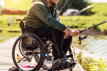Young disabled man in a wheelchair fishing.