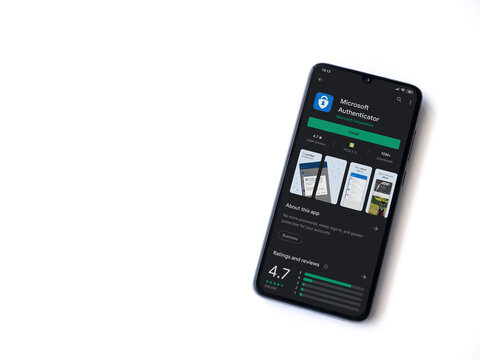 Lod, Israel - July 8, 2020: Microsoft Authenticator app play store page on the display of a black mobile smartphone isolated on white background. Top view flat lay with copy space.