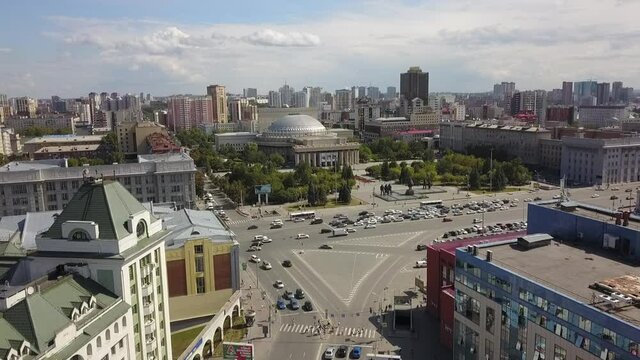 The flying camera shows the main attractions of Novosibirsk with a view of the city from and road traffic.