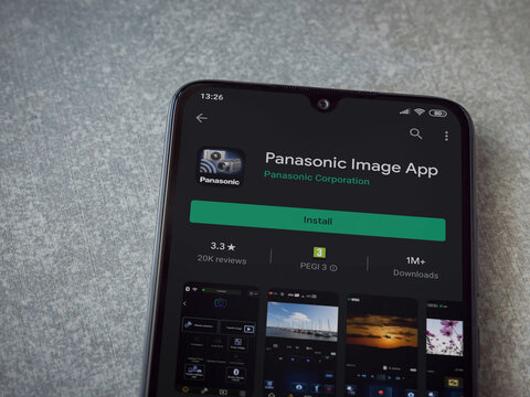Lod, Israel - July 8, 2020: Panasonic Image App app play store page on the display of a black mobile smartphone on ceramic stone background. Top view flat lay with copy space.
