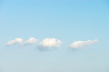 Puffy white clouds against blue sky background