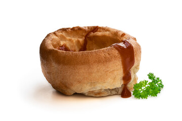 Yorkshire puddings with brown sauce isolated on white background