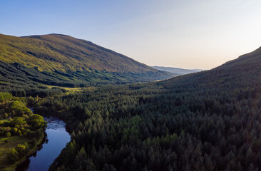 aerial view of glen orchy in the argyll region of the highlands of scotland during an autumn evening as the sun sets casting the glen into shadow