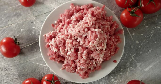 A pile of raw minced meat on a plate slowly rotates. 