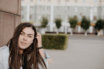 Portrait of a beautiful young woman with natural light outdoors in the city