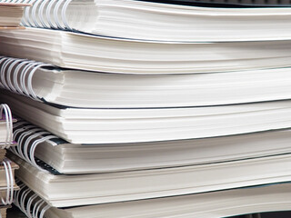Spring-bound documents. Documents fastened by a spring. Craft notepads. Stack of documents. Many notebooks, different notebook springs