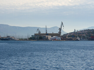  Port cranes for unloading and loading ship transport, Croatia port in the city of Trogir