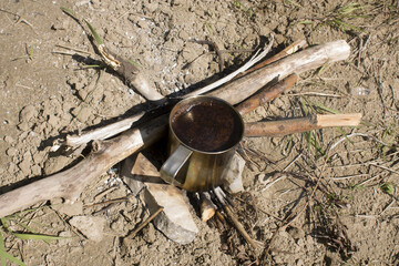 cooking coffee on fire in steel cup
