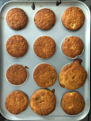 Looking down at homemade cakes cooking in a baking tray.