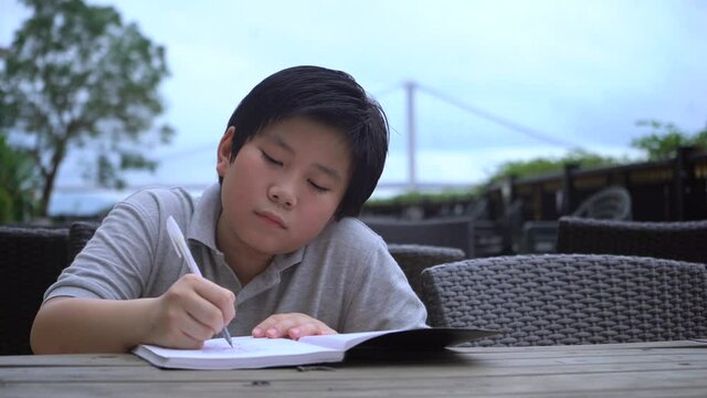 Asian Boy doing homework and study so hard