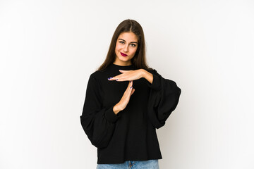 Young caucasian woman isolated on white background showing a timeout gesture.