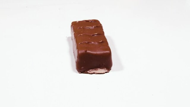 slicing snickers on isolated background. animation shows inside of Chocolate bar with caramel 4K