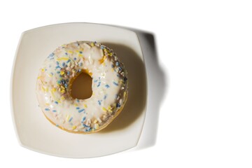 Close up view of sugar donut on white plate isolated. Health and food background. 