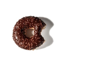 Close up view of bitten chocolate donut on white background isolated. Food and health concept.