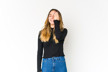 Young caucasian woman isolated on white background laughing happy, carefree, natural emotion.