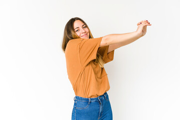 Young caucasian woman isolated on white background stretching arms, relaxed position.