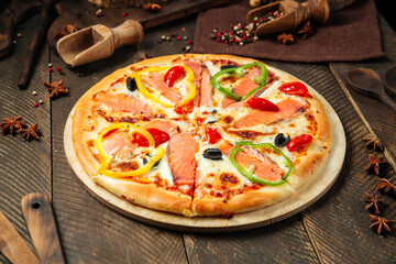 Side view on pizza with salmon and bell pepper