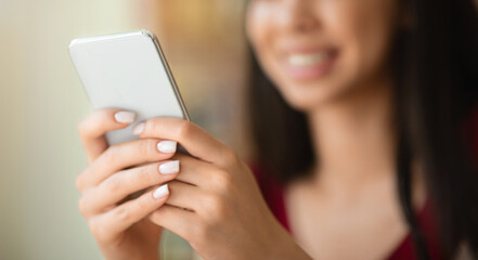 Closeup Image Of Unrecognizable Woman Using Modern Smartphone, Texting Or Browsing Internet