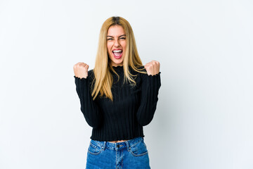 Young blonde woman isolated on white background cheering carefree and excited. Victory concept.