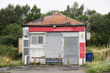 Derelict abandoned shop business in poor housing crisis ghetto estate slum Paisley