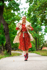 Young beautiful blonde woman in a bright red dress