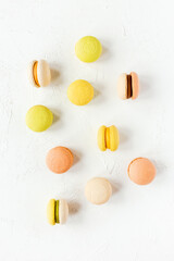 Colorful french macarons on white background, flatlay, top view