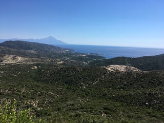 Mountain landscape on sunny summer day with clear sky in Greece with sea on background