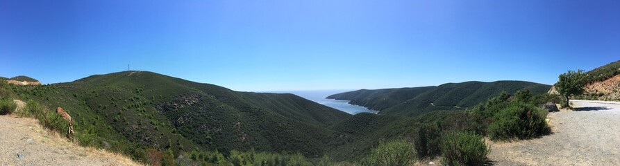 Mountain landscape panorama on sunny summer day with clear sky in Greece with sea gulf on background
