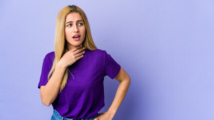 Young blonde woman isolated on purple background suffers pain in throat due a virus or infection.