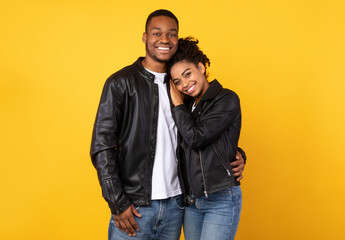 Happy Black Couple Embracing Posing Standing On Yellow Studio Background