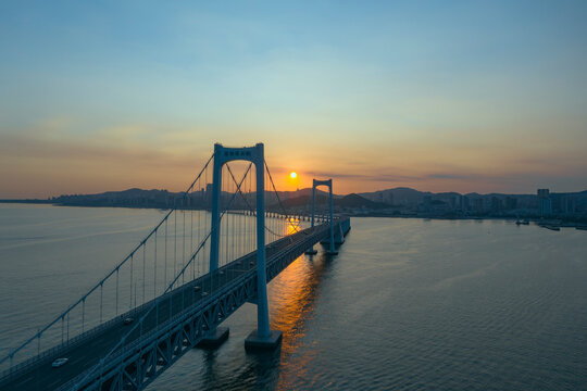 Aerial photo of the cross sea bridge at sunset was taken in Dalian, Liaoning Province, China