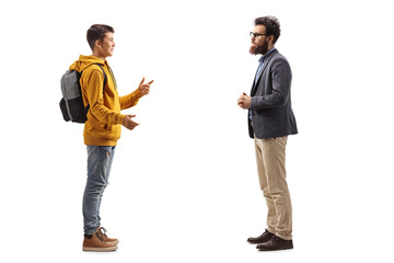 Full length profile shot of a male teenager talking to a beared man