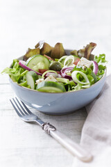 Salad with Green Olives, Cucumber and Feta Cheese. Bright wooden background. 