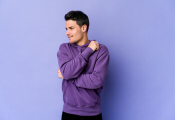 Young caucasian man isolated on purple background confused, feels doubtful and unsure.