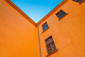 Fototapeta na wymiar Old orange industrial building under blue sky