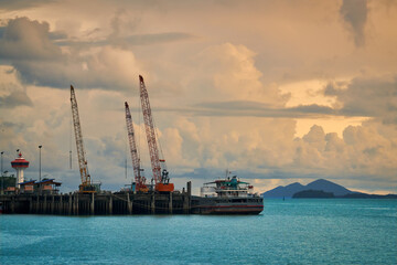 Fototapeta premium ranong seascape with sea dock and lighthouse in sunset skyline and cloud