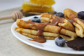 crepes with blueberries. pancakes with fruit. pancakes with berries. pancakes with honey, raspberries, blueberries and chocolate