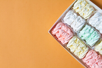 Flat lay with a plate of home-made marshmallows (zephyr, meringue) made with apple and mint,...