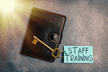 Text sign showing Staff Training. Business photo text program that helps employees learn specific knowledge Paper accesories with digital smartphone arranged on different background