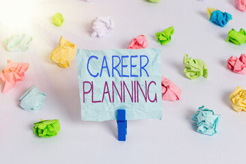 Handwriting text Career Planning. Conceptual photo Strategically plan your career goals and work success Colored crumpled papers empty reminder white floor background clothespin