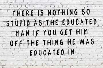 Black painted inscription of smart quote on white brick wall
