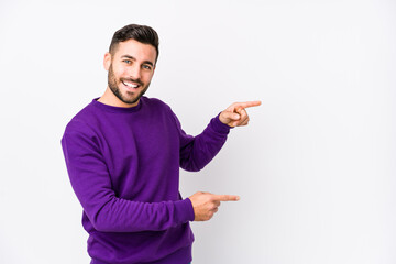 Young caucasian man against a white background isolated excited pointing with forefingers away. - Powered by Adobe
