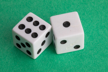 lucky seven - a pair of dice on a green background showing six and one