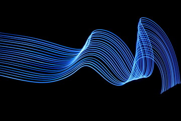 Long exposure photograph of neon blue colour in an abstract swirl, parallel lines pattern against a black background. Light painting photography
